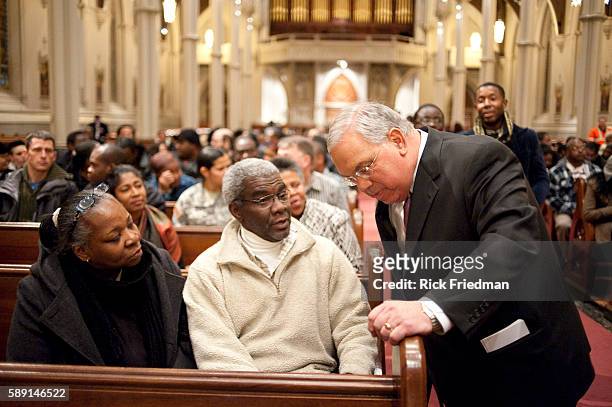 Boston Mayor Tom Menino talks with Jean and Darleen Alexandre and other members of Boston's Haitian community at an informational meeting on the...
