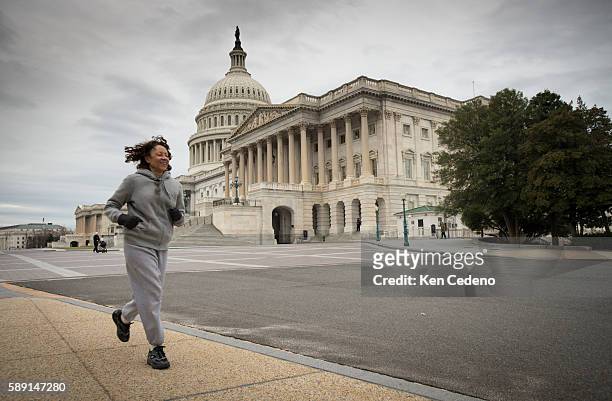 Jogger runs past the U.S. Capitol at the beginning of a new year Jan 1, 2013 following the "fiscal cliff" deal made Dec 31, 2012 on Capitol Hill in...