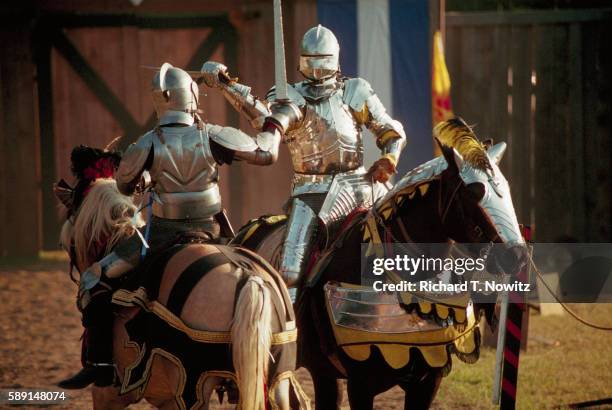 two knights jousting at renaissance fair - ritterturnier stock-fotos und bilder