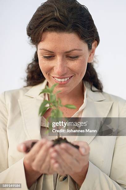 woman carrying sapling - lifestyle mann portrait stock pictures, royalty-free photos & images