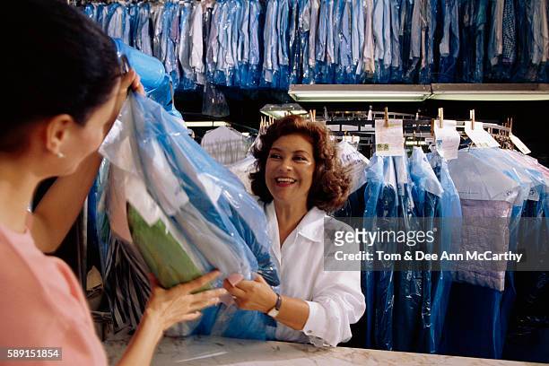 dry cleaner with customer - dry cleaning shop stock pictures, royalty-free photos & images