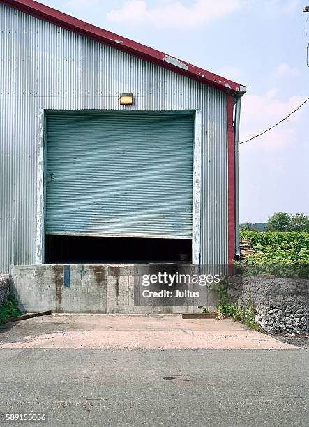 open garage door at loading dock - dock door stock pictures, royalty-free photos & images