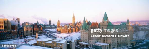 ottawa's chateau laurier hotel and parliament buildings in winter - ottawa stock pictures, royalty-free photos & images