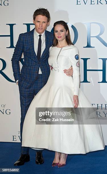 Felicity Jones, wearing a Christian Dior haute couture dress, and Eddie Redmayne arriving at the UK premiere of "The Theory of Everything" at the...