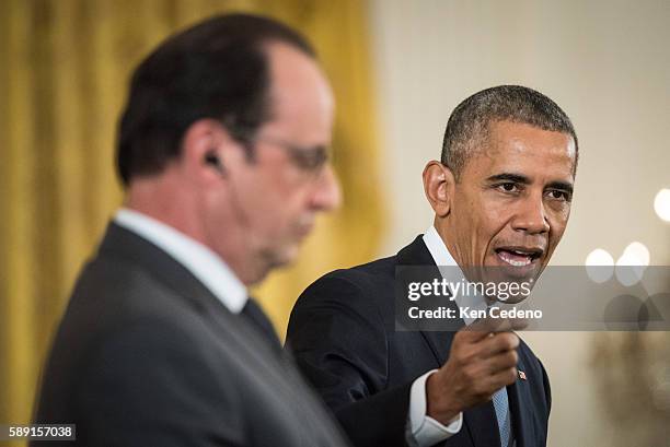 President Barack Obama answers reporters questions during a news conference with French President Francois Hollande in the East Room after a...
