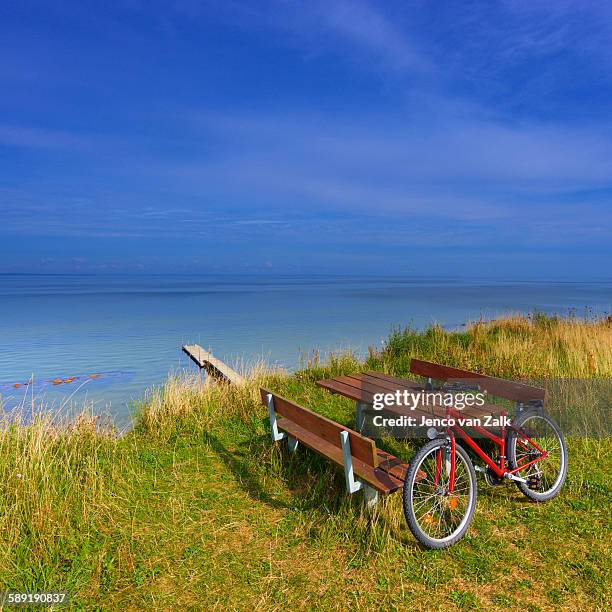 bike on the shore - jenco van zalk stock pictures, royalty-free photos & images