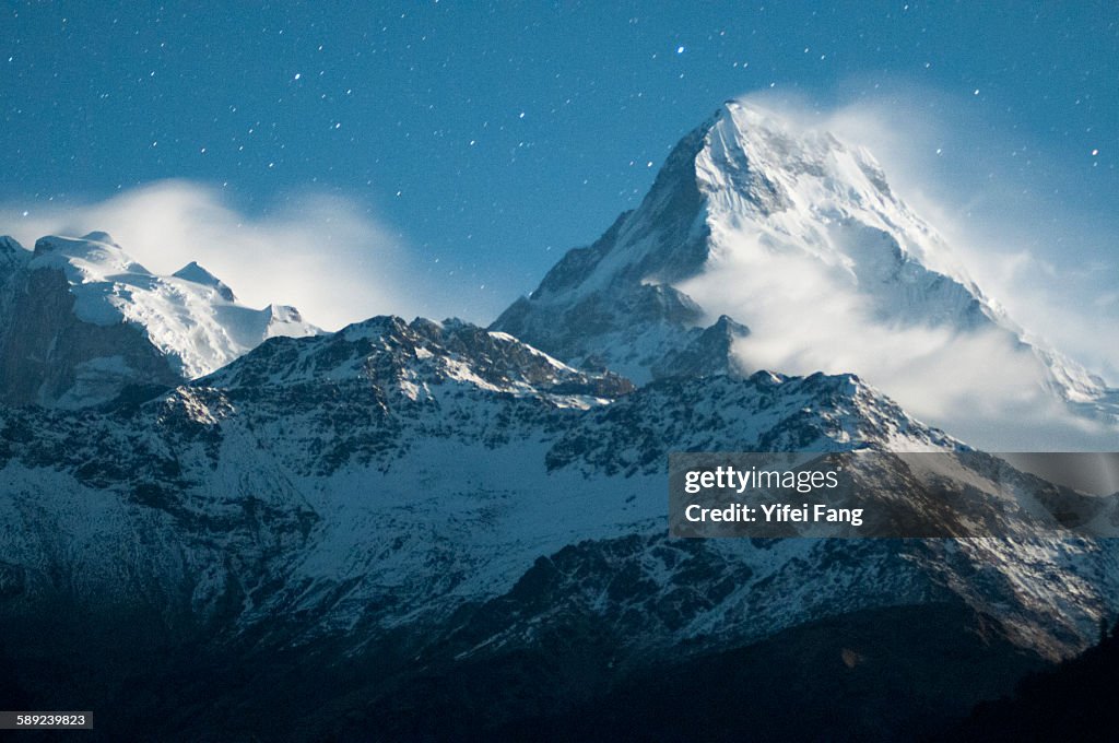 Snowy peak under starlit sky