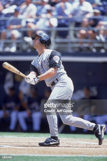 Jay Bell of the San Diego Padres keeps his eye on the ball after hitting it during the game against the Arizona Diamondbacks at Qualcomm Stadium in...