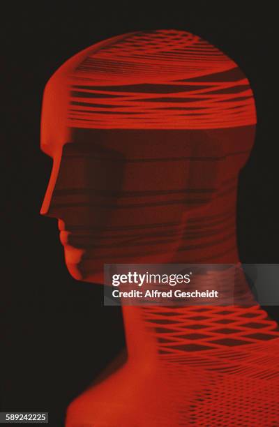 Mannequin head with an image of a red computerised grid superimposed over it, 1985.