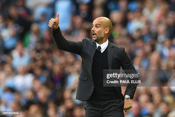 Manchester City's Spanish manager Pep Guardiola gestures from the touchline during the English Premier League football match between Manchester City...