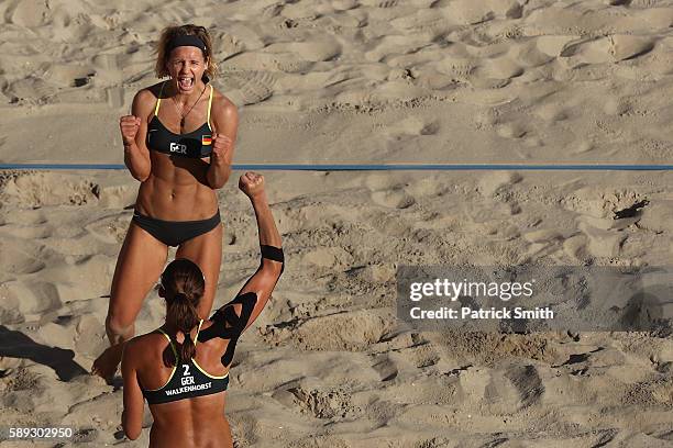 Laura Ludwig of Germany celebrates with teammates Kira Walkenhorst after defeating Switzerland during a Women's Round of 16 match on Day 8 of the Rio...