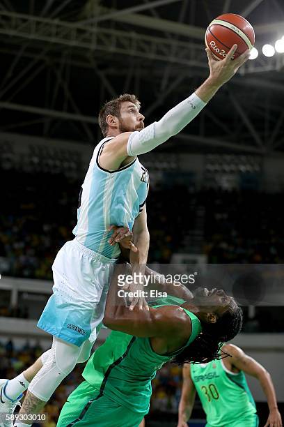 Andres Nocioni of Argentina collides with Nene Hilario of Brazil as he heads for the net in the first half on Day 8 of the Rio 2016 Olympic Games at...