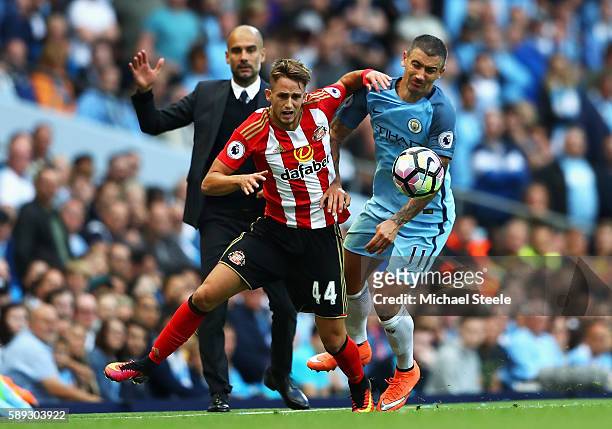 Adnan Januzaj of Sunderland battle for possession with Aleksander Kolorov of Manchester City during the Premier League match between Manchester City...
