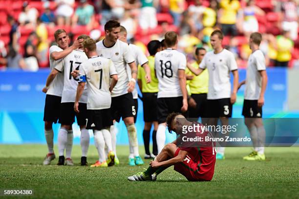 Fernando of Portugal reacts as team Germany celbrates their 4-0 wn over Portugal during the second half of the Men's Football Quarterfinal match on...