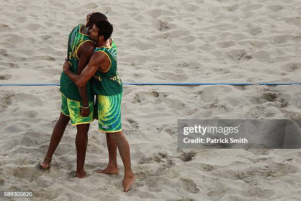 Evandro Goncalves Oliveira Junior of Brazil celebrates with teammates Pedro Solberg during a Men's Round of 16 match between Brazil and Russia on Day...