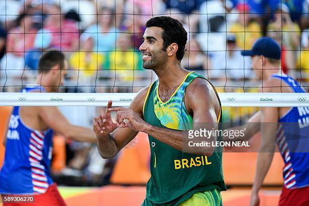 Brazil's Pedro Solberg gestures after winning a point during the men's beach volleyball round of 16 match between Brazil and Russia at the Beach...