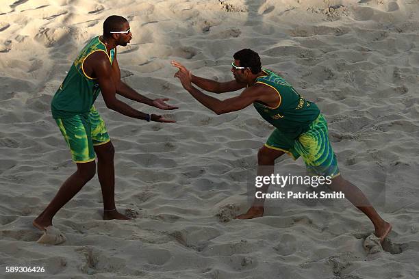 Evandro Goncalves Oliveira Junior of Brazil celebrates with teammate Pedro Solberg during a Men's Round of 16 match between Brazil and Russia on Day...