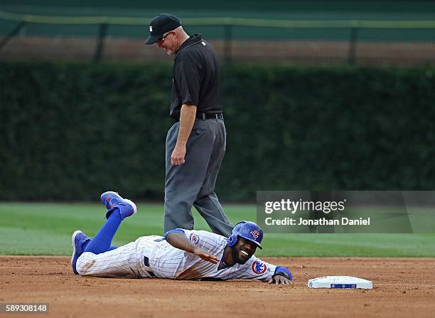 Dexter Fowler of the Chicago Cubs smiles and slaps the ground after being called out trying to steal second base by umpire Ron Kulpa in the 5th...