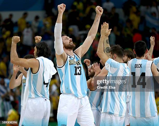 Andres Nocioni of Argentina and the rest of this teammates celebrate the 111-107 double overtime win over Brazil during the Men's Preliminary Round...