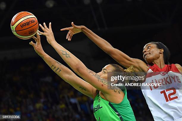 Brazil's centre Erika Souza goes to the basket past Turkey's centre Lara Sanders during a Women's round Group A basketball match between Turkey and...