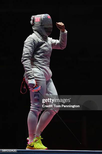 Ibtihaj Muhammad of the United States celebrates a point against Irene Vecchi of Italy during the Women's Sabre Team bronze medal match between...