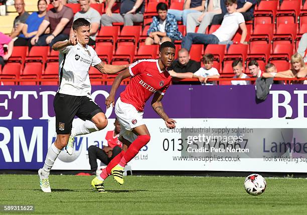 Ezri Konsa of Charlton Athletic looks to the ball with Alex Revell of Northampton Town during the Sky Bet League One match between Charlton Athletic...