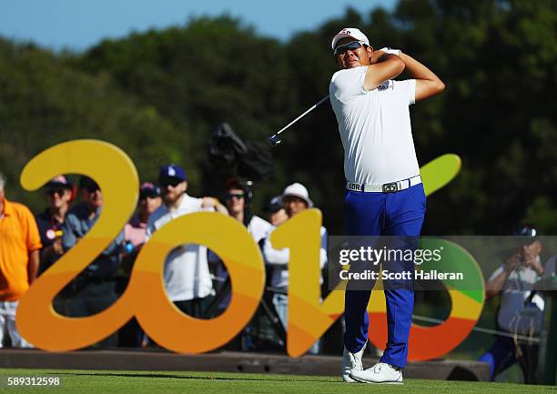 Byeong-hun An of Korea hits his tee shot on the 16th hole during the third round of the golf on Day 8 of the Rio 2016 Olympic Games at the Olympic...