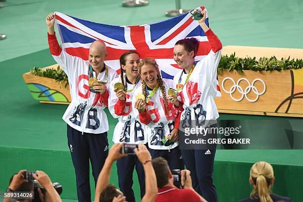 Gold medallists Britain's Joanna Rowsell-Shand, Britain's Elinor Barker, Britain's Laura Trott and Britain's Katie Archibald pose with a flag and...