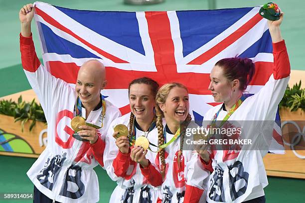 Gold medallists Britain's Joanna Rowsell-Shand, Britain's Elinor Barker, Britain's Laura Trott and Britain's Katie Archibald pose with a flag and...