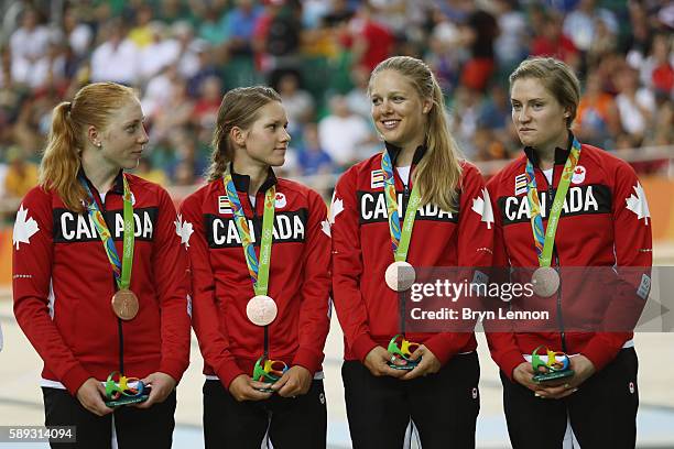 Bronze medalists Allison Beveridge, Jasmin Glaesser, Kirsti Lay and Georgia Simmerling of Canada celebrate on the podium at the medal ceremony for...