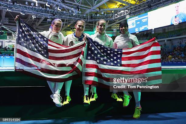 Dagmara Wozniak, Monica Aksamit, Mariel Zagunis and Ibtihaj Muhammad of the United States celebrate after winning the Women's Sabre Team bronze medal...
