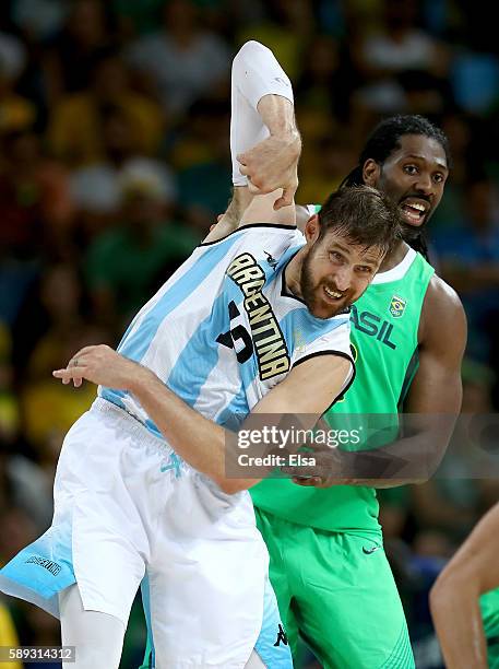 Andres Nocioni;and Nene Hilario of Brazil fight for position during the Men's Preliminary Round Group B match on day 8 of the Rio 2016 Olympic Games...