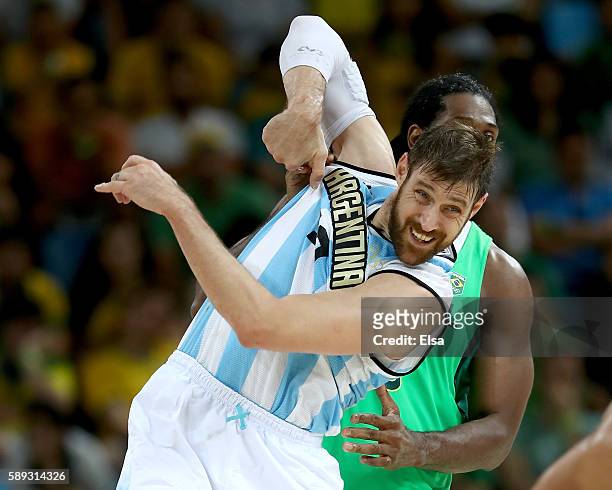 Andres Nocioni;and Nene Hilario of Brazil fight for position during the Men's Preliminary Round Group B match on day 8 of the Rio 2016 Olympic Games...