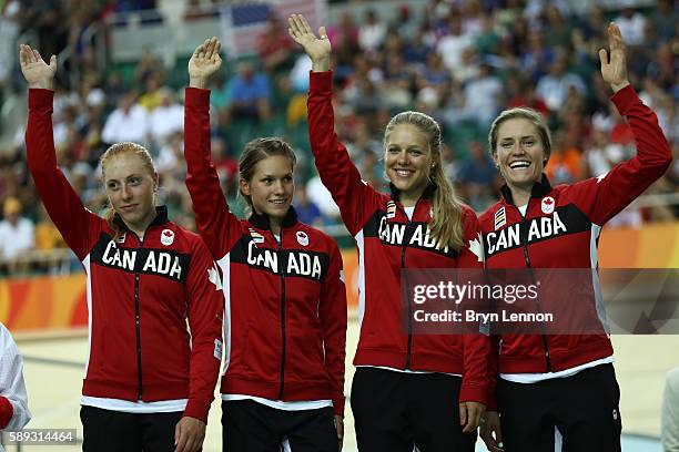 Bronze medalists Allison Beveridge, Jasmin Glaesser, Kirsti Lay and Georgia Simmerling of Canada celebrate on the podium at the medal ceremony for...