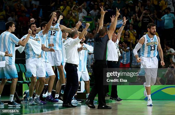 The Argentina celebrates after teammate Andres Nocioni hit a three point shot in the overtime against Brazil during the Men's Preliminary Round Group...