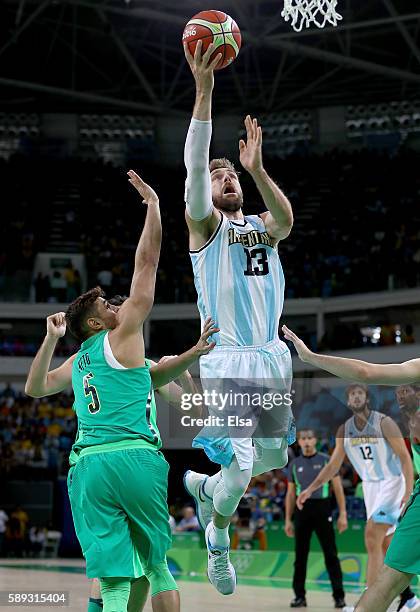 Andres Nocioni of Argentina takes a shot as Raulzinho Neto of Brazil defends during the Men's Preliminary Round Group B match on day 8 of the Rio...