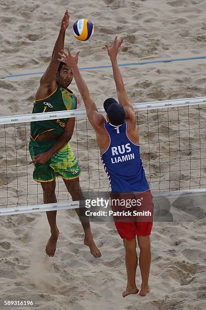 Pedro Solberg of Brazil spikes the ball against Nikita Liamin of Russia during a Men's Round of 16 match between Brazil and Russia on Day 8 of the...