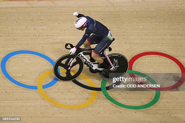 Britain's Jason Kenny reacts after coming in ahead of Russia's Denis Dmitriev during the men's Sprint semi-finals track cycling event at the...