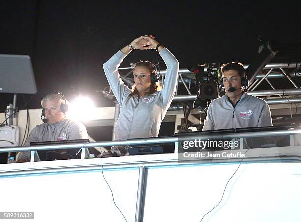 Commentator for French TV Laure Manaudou - between Philippe Lucas and Alexandre Boyon - reacts during the Men's 50m Freestyle Final her brother...