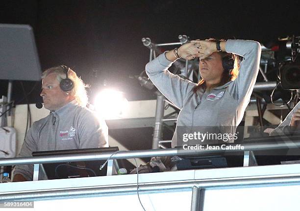 Commentator for French TV Laure Manaudou - alongside Philippe Lucas - reacts during the Men's 50m Freestyle Final her brother Florent Manaudou of...