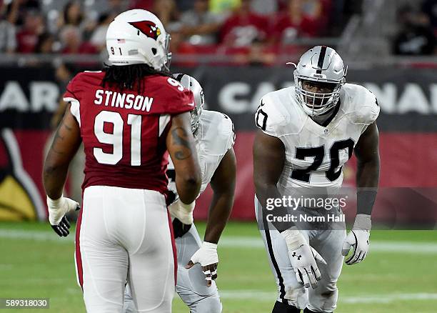 Kelechi Osemele of the Oakland Raiders gets ready to pass block against Ed Stinson of the Arizona Cardinals during the first half at University of...