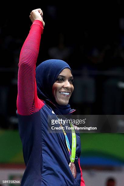 Bronze medalist, Ibtihaj Muhammad of the United States celebrates on the podium during the Women's Sabre Team bronze medal match between United...