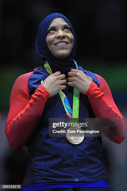 Bronze medalist, Ibtihaj Muhammad of the United States celebrates on the podium during the Women's Sabre Team bronze medal match between United...