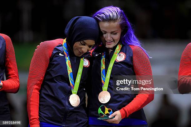 Bronze medalist, Ibtihaj Muhammad of the United States celebrates on the podium with Dagmara Wozniak of the United States during the Women's Sabre...