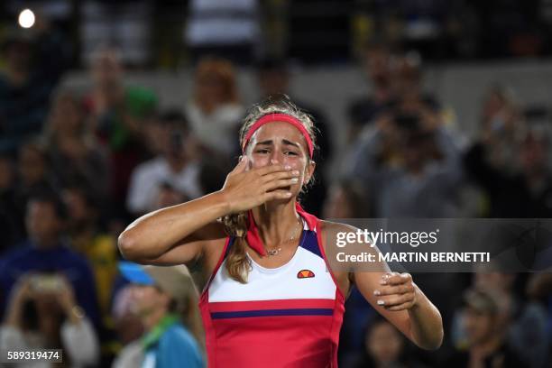Puerto Rico's Monica Puig reacts after winning her women's singles final tennis match against Germany's Angelique Kerber at the Olympic Tennis Centre...
