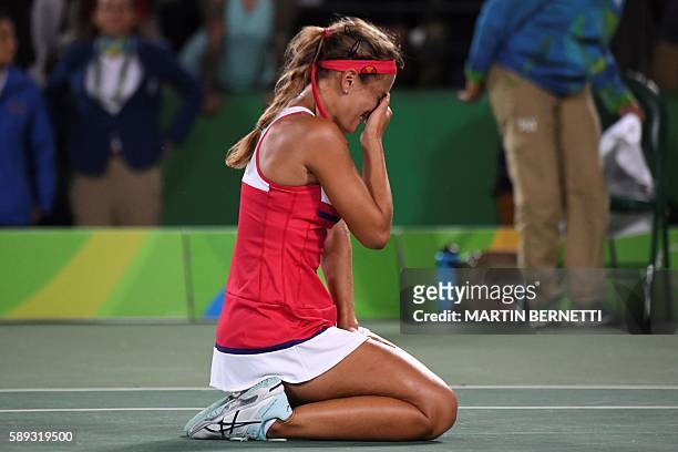 Puerto Rico's Monica Puig reacts after winning her women's singles final tennis match against Germany's Angelique Kerber at the Olympic Tennis Centre...