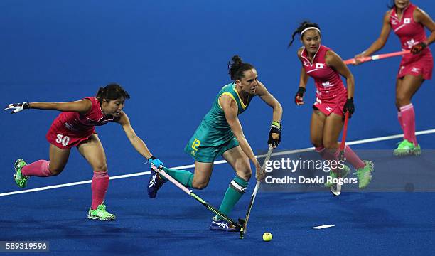Madonna Blyth of Australlia moves past Minami Shimizu during the Women's Pool B hockey match between Australia and Japan on Day 8 of the Rio 2016...