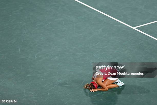 Monica Puig of Puerto Rico reacts after defeating Angelique Kerber of Germany in the Women's Singles Gold Medal Match on Day 8 of the Rio 2016...