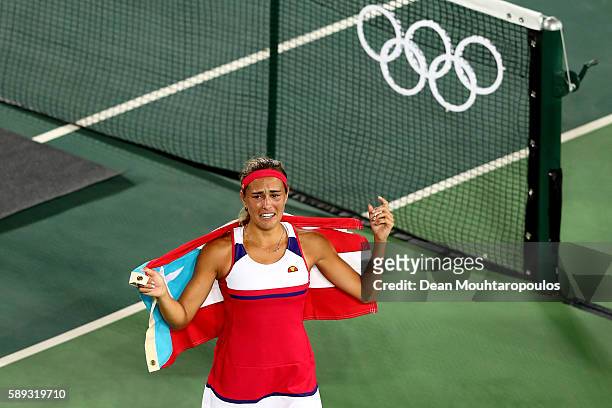Monica Puig of Puerto Rico reacts after defeating Angelique Kerber of Germany in the Women's Singles Gold Medal Match on Day 8 of the Rio 2016...