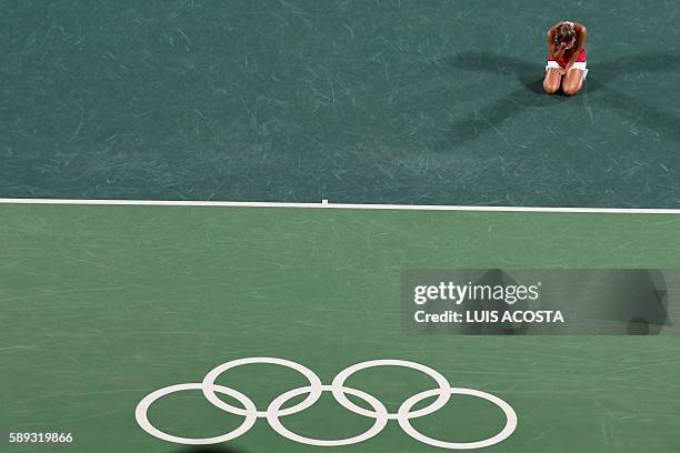 Puerto Rico's Monica Puig reacts after winning her women's singles final tennis match against Germany's Angelique Kerber at the Olympic Tennis Centre...